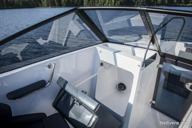 Modern boat interior with a sleek dashboard and seating, overlooking a serene water landscape. Visible text reads "MODULAR.